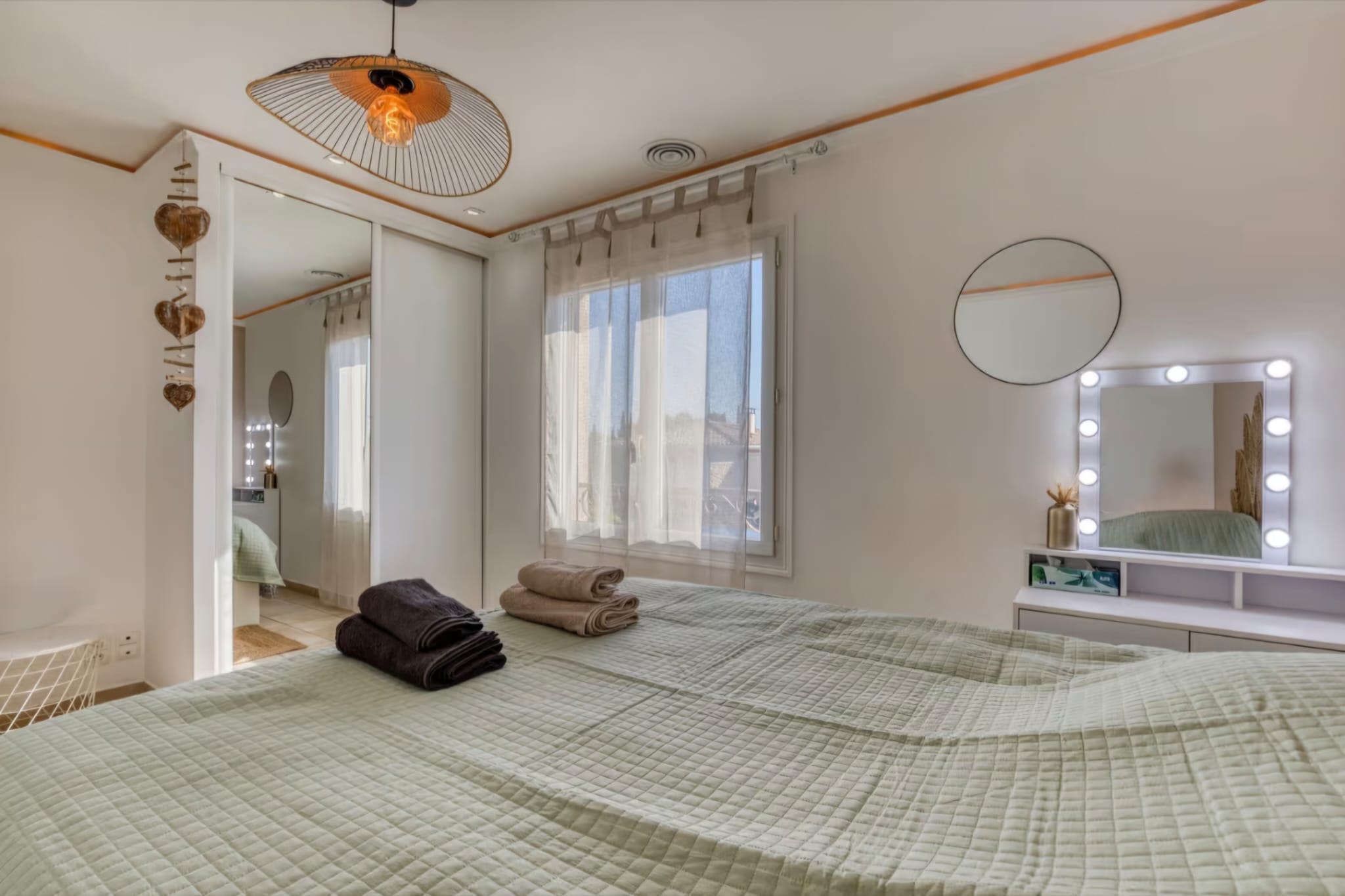 Chambre Sauge avec miroir de loge lumineux et lit vert